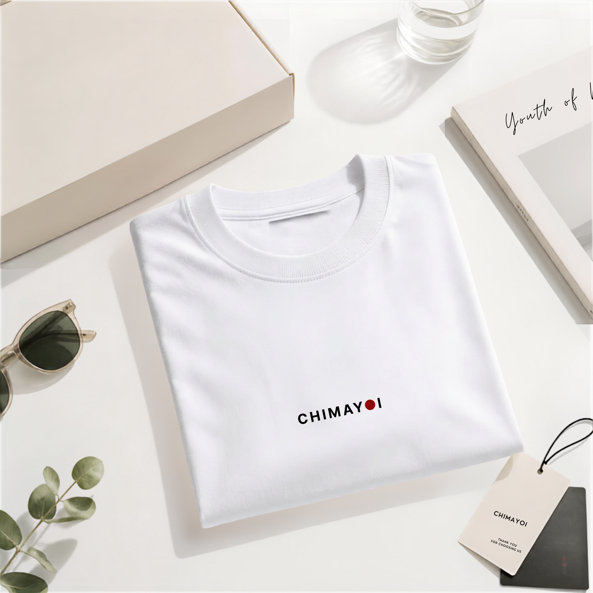 Flat lay of CHIMAYOI White embroidered logo tee folded neatly with minimalist props, showcasing high-end streetwear details.