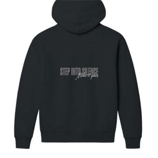 Back view of black heavyweight unisex hoodie featuring bold Step Into Silence script